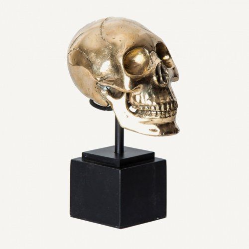Busto dorado con forma de calavera