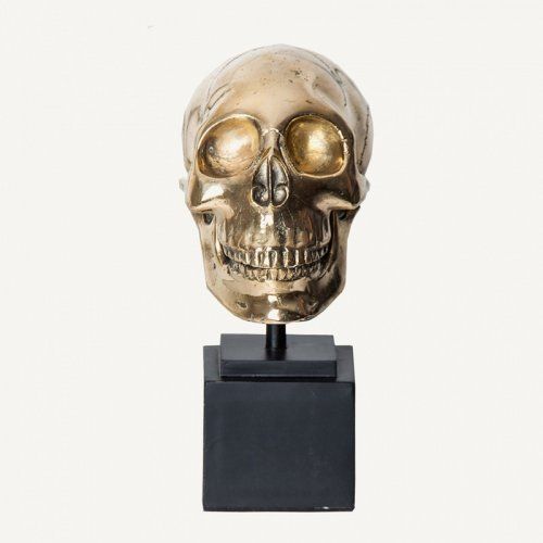 Busto dorado con forma de calavera